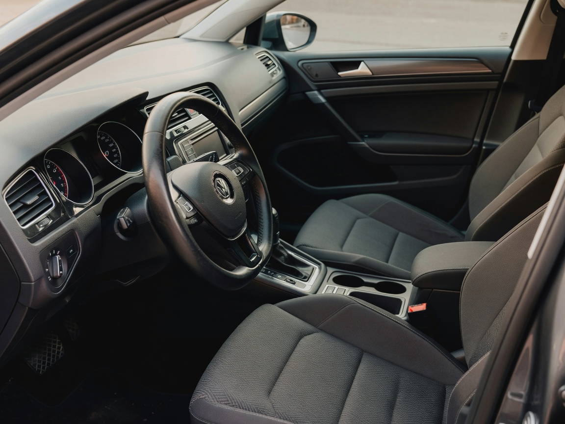 Documentary-style photograph of a real everyday European vehicle interior showing authentic dashboard textures and natural lighting